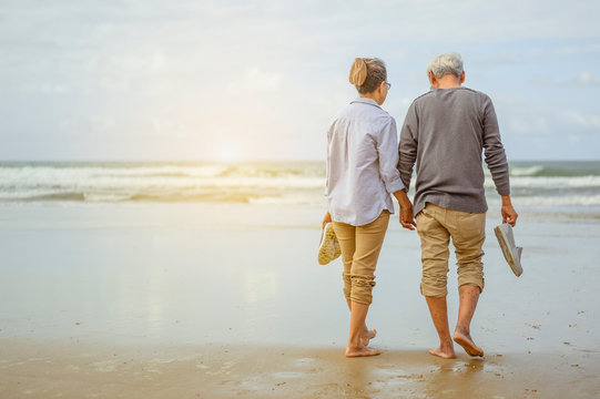 Retirees walking on the beach